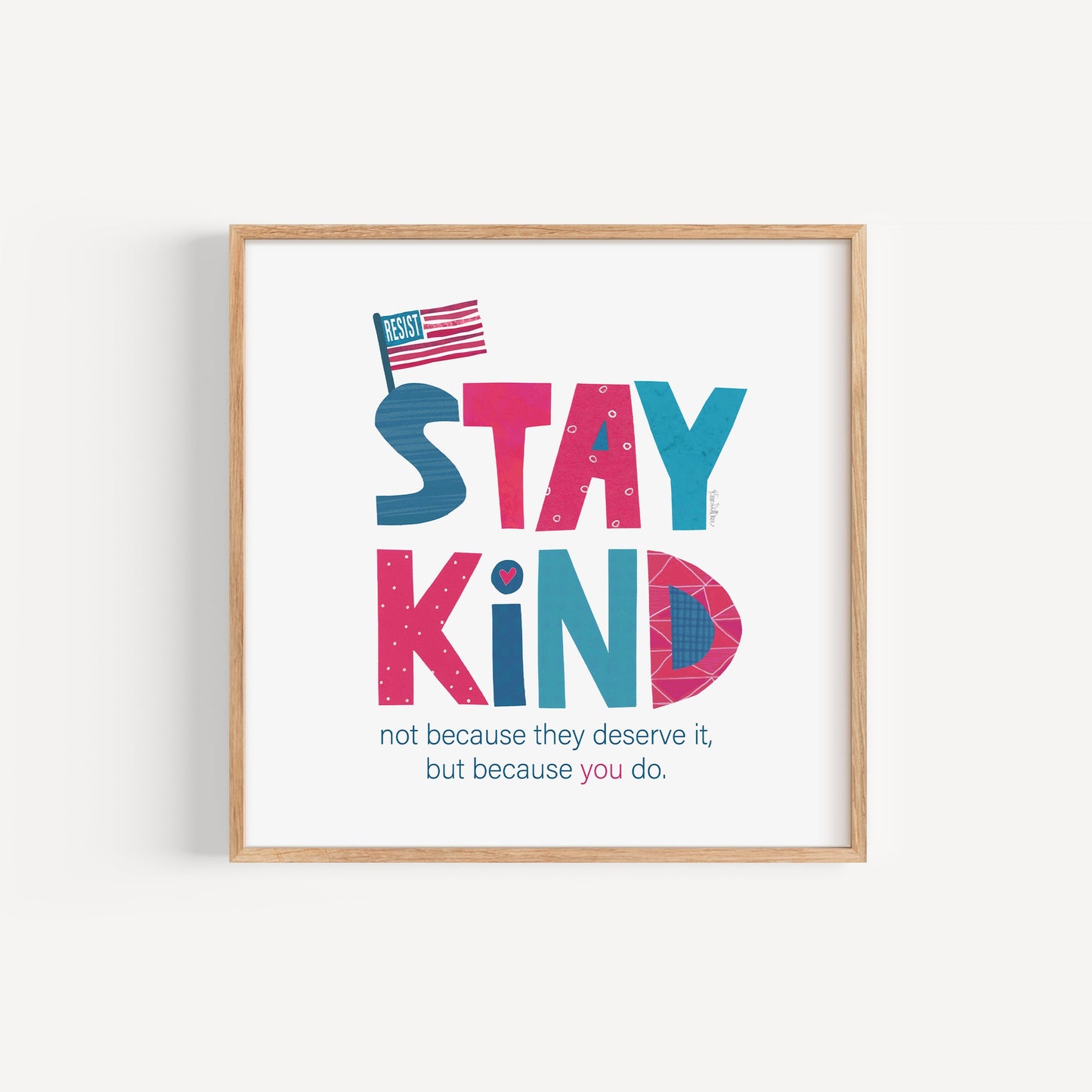 Framed poster with 'Stay Kind' text on a white background