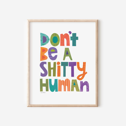 Framed colorful poster with text 'Don't be a Shitty Human' on a white background