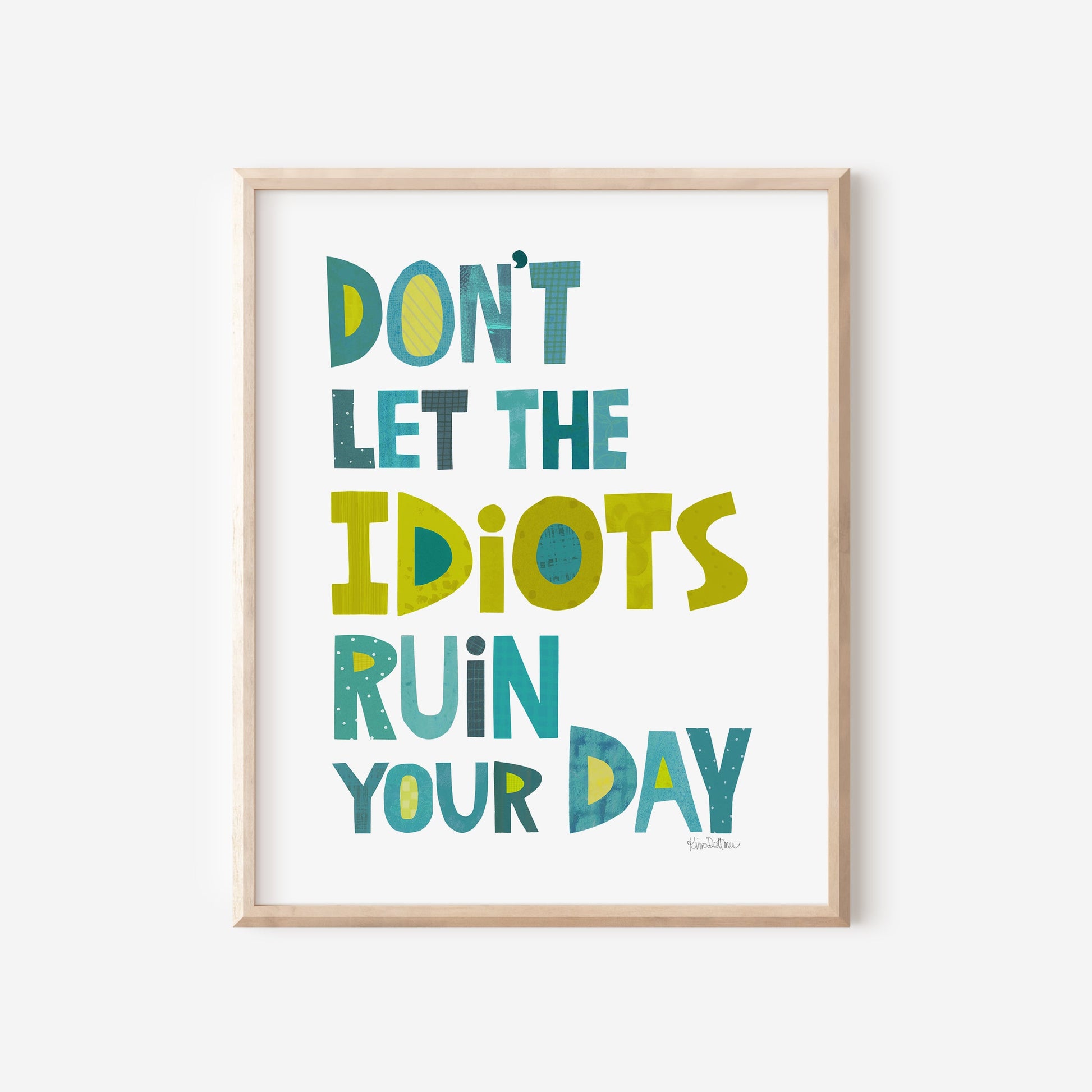 Framed print with motivational quote 'Don't let the idiots ruin your day' on a white background
